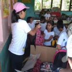 The first contingent of volunteers from the British School Manila distribute school supplies to a local school.